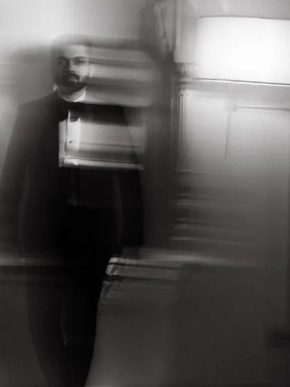 A moody and artistic motion-blur portrait of the groom in his tuxedo, captured in black and white for a timeless, cinematic feel.