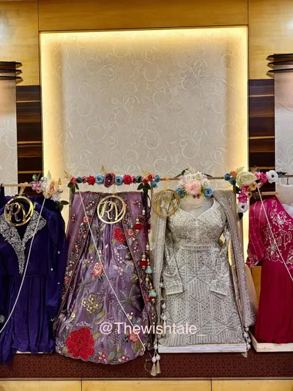 This is my happy place, surrounded by gorgeous wedding outfits! I specialize in trousseau packing, making sure every single piece, from heavy lehengas to delicate suits, is presented beautifully with custom floral arrangements and personalized initial tags.