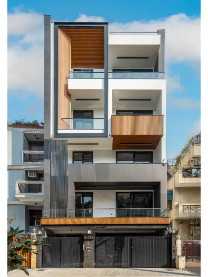 Our completed facade project in Greater Kailash 2, Delhi. This 300 sq. yard elevation is a symphony of texture and depth, using a robust C-channel framing system, wooden finish elements, and sleek aluminum fluted panels.