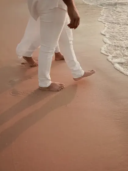 A detail shot of their feet walking along the shoreline. Sometimes the smallest details tell the biggest story of a shared journey.