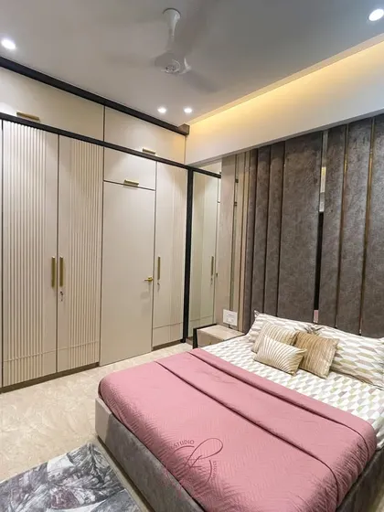 This angle highlights the seamless integration of the wardrobes and the bed, creating a cohesive and well-designed space. The neutral color palette is both timeless and calming.