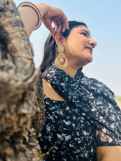 A customer wearing our heavy-look pearl chandbalis and matching maang tika.