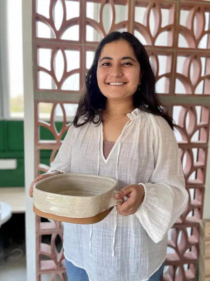 Introducing Mansa, a professional course student, holding one of her beautifully crafted baking dishes.