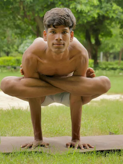 The Kukkutasana, or Rooster Pose, is an advanced arm balance performed with legs in lotus. It builds serious arm and core strength.
