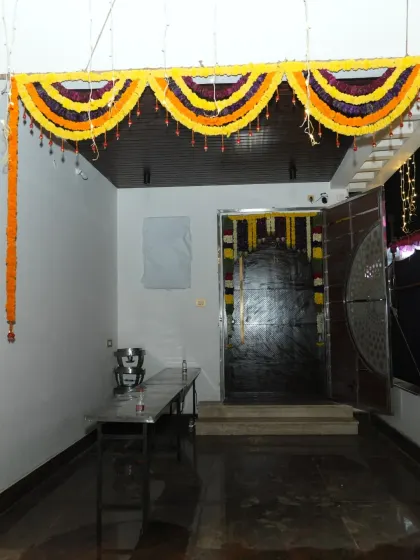 The entrance passage of a house decorated with marigold garlands for a housewarming ceremony.