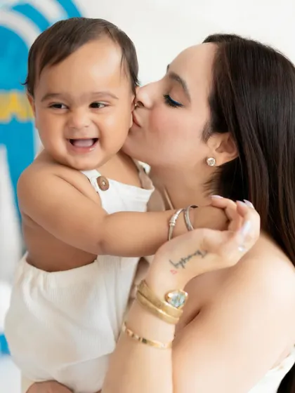 A mother's kiss for the birthday boy. We always encourage parents to jump in for a few shots during milestone sessions to capture these precious family connections.