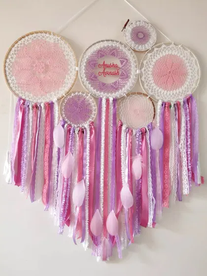 A mesmerizing pink and purple cluster dreamcatcher, personalized for 'Anisha' and 'Avinash'. The intricate crochet work and soft feathers make it a true statement piece.