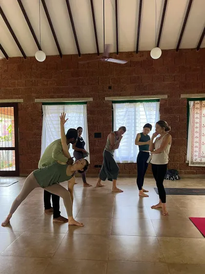 Adjusting a student in Trikonasana (Triangle Pose) requires a keen eye for alignment. Our workshops provide practical tools to improve alignment for students in every class you teach.