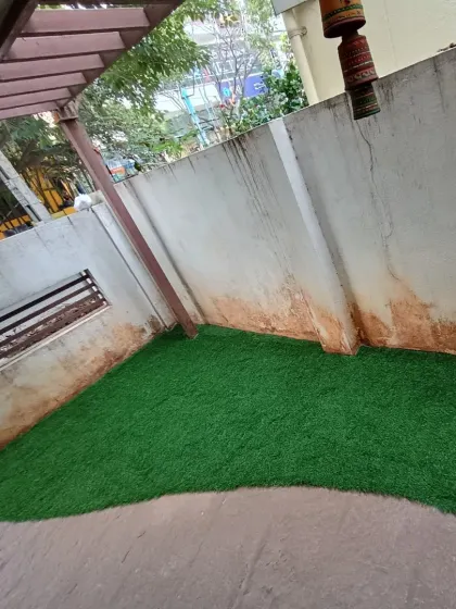 I installed this curved section of artificial grass to create a soft, green area in a partially covered courtyard.