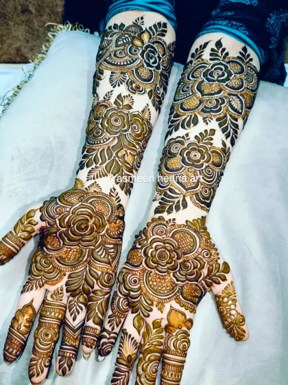 A full view of this stunning rose-themed bridal mehndi, showcasing the detailed work on both hands.