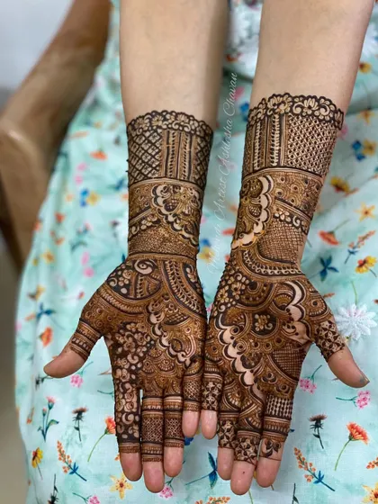 A beautiful mehendi design with a mix of traditional and modern elements. The patterns are intricate and create a rich, textured look.