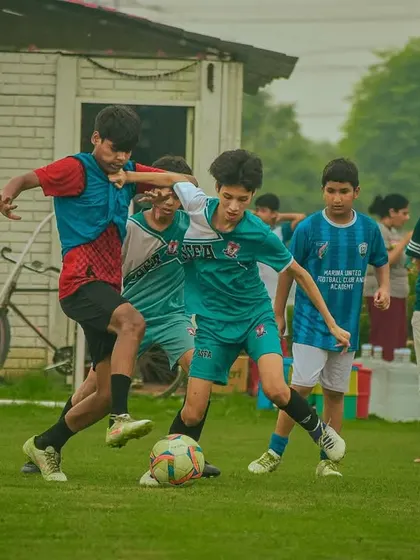 Intense action with multiple players fighting for the ball.