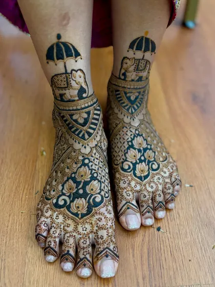 Another view of the elephant umbrella design, showing the rich, dark henna paste.