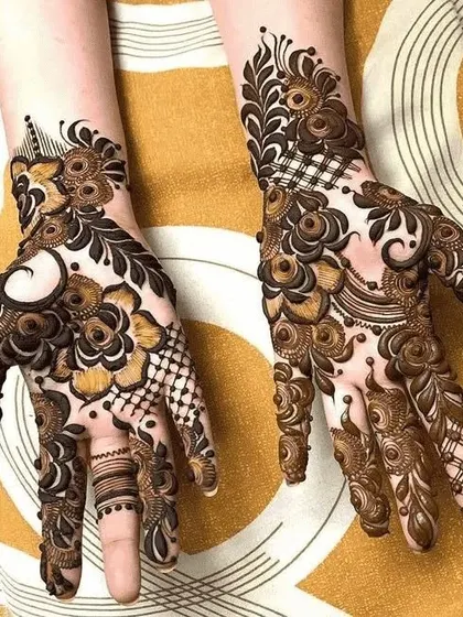 Two hands with very detailed and different designs, one with checkerboard filling and the other with swirls.