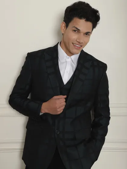 When the occasion is formal, wear a tailored suit. This black checkered three-piece suit is a modern classic.