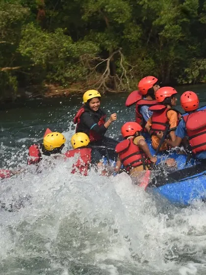 Laughter and splashes fill the air as a team enjoys the bumpy ride through the rapids. It's not just about adrenaline; it's about having fun.