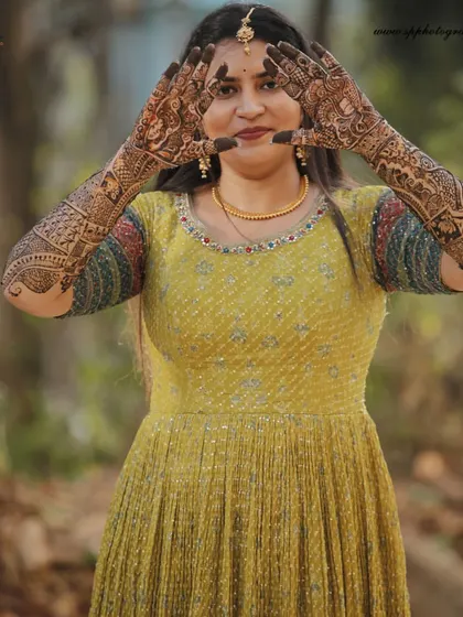 A beautiful portrait of a bride showcasing her intricate Mehndi design. We make sure to capture the artistry of the henna before the main wedding day celebrations begin.