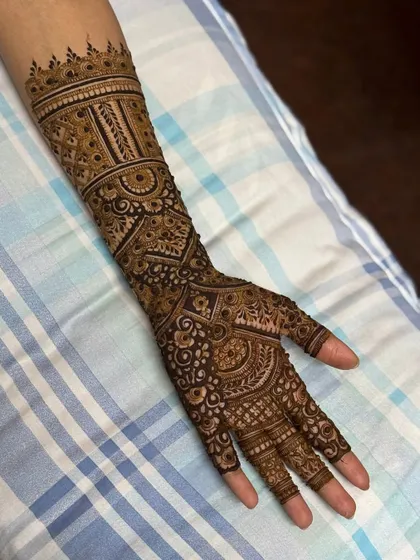 A lovely engagement henna design that covers the arm with beautiful, intricate patterns.