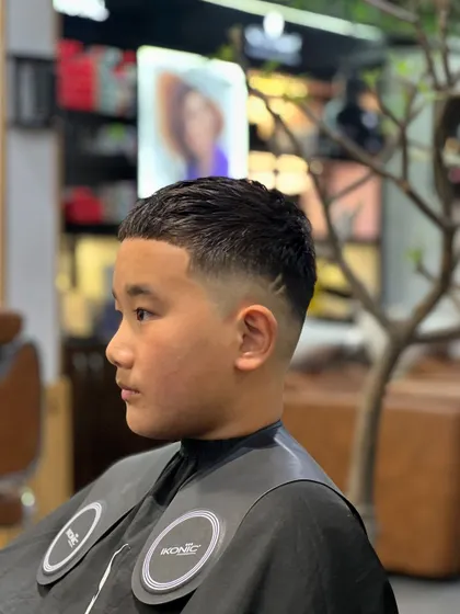 A classic low fade haircut. This timeless style is perfect for any occasion and can be customized to suit your preference.