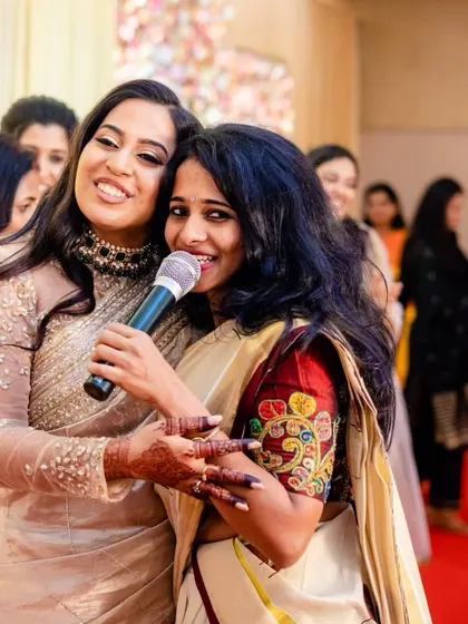 Our anchor shares the mic with a happy bride. We build strong connections with the families we work with, becoming a part of their celebration.
