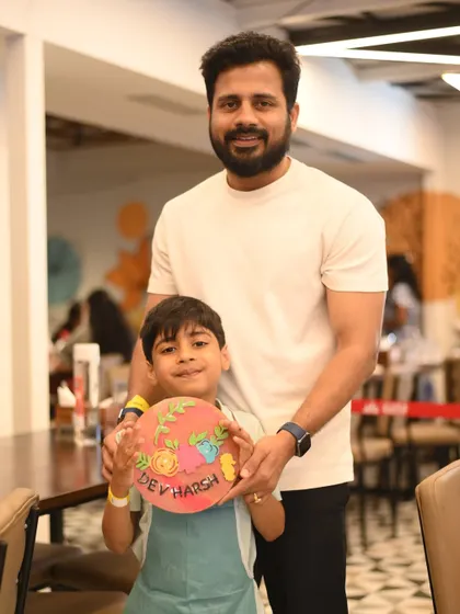 This father and son are all smiles with their finished artwork. It's a wonderful way to celebrate fatherhood and create a lasting memory.