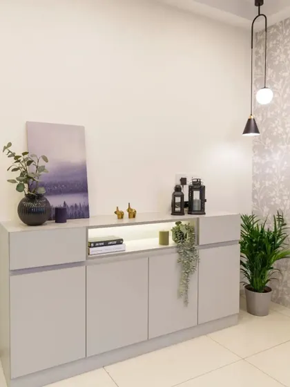 A minimalist crockery unit with a subtle wallpapered accent wall and a modern pendant light.