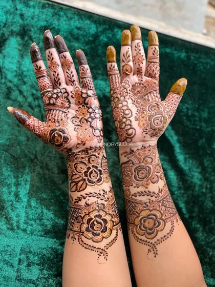This design is a gorgeous fusion of styles, with bold, dark-filled roses on one arm and more delicate, shaded florals on the other, creating a unique and asymmetrical look.