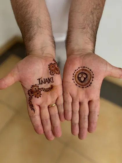 A simple and personal design for a male guest, featuring his name and a small motif. It was his first time getting henna and he loved it.