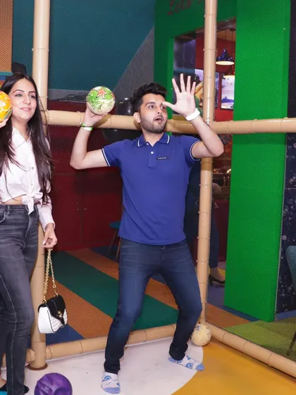 Even the adults can't resist joining in on the fun. Here, guests are enjoying one of the many ball games available in the play area.