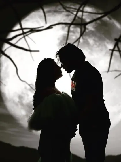 This is one of my more artistic styles. A silhouette maternity portrait set against a full moon creates a dramatic and deeply romantic image, focusing on the couple's connection and the beautiful shape of the baby bump.