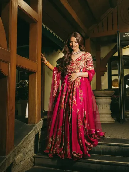 A full-length view of Vasav's elegant welcome dinner outfit. Her minimal makeup allows the intricate details of her dress to take center stage.