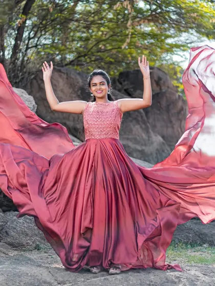 The rich color and flowing fabric of this rental gown look incredible against natural landscapes like these rocks.