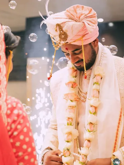 A candid shot of the groom during the varmala ceremony, with soap bubbles adding a dreamy and whimsical touch.