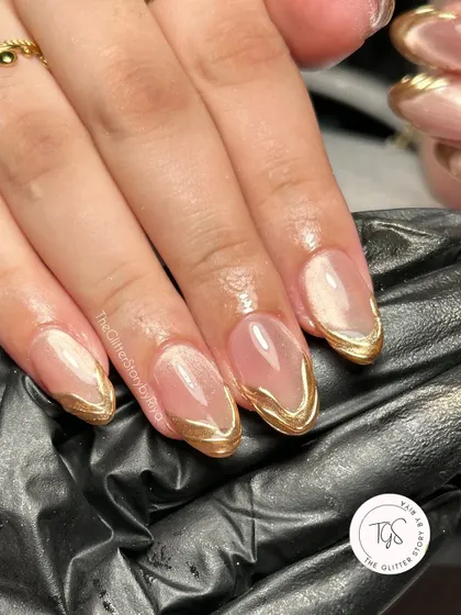 A close-up of a stunning Diwali-inspired nail set. This image highlights the clean lines of the gold chrome French tip over a shimmery cat-eye base.
