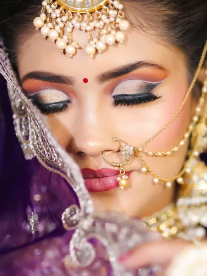 A beautiful shot capturing the artistry of the eye makeup, with shimmering lids and dramatic lashes. We teach our students how to create eye looks that captivate.