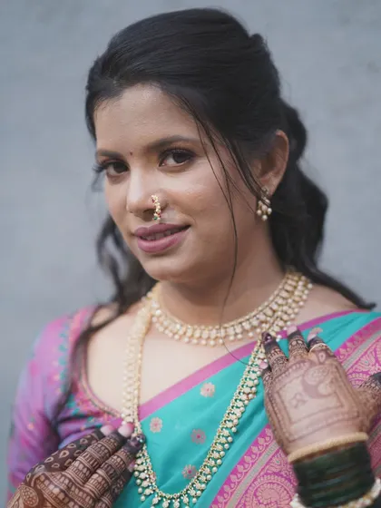 A close-up showing the intricate henna design and the bride's soft, well-defined makeup.