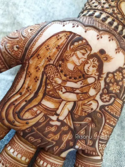 A close-up of the exquisite figure work of Yashoda and Krishna, symbolizing the beauty of motherhood. The fine details in their expressions and attire make this a cherished design for a baby shower.