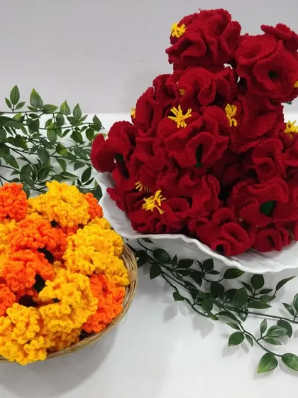 An assortment of my handmade crochet flowers. The vibrant red hibiscus and sunny orange and yellow marigolds can be used to brighten up any corner of your home.