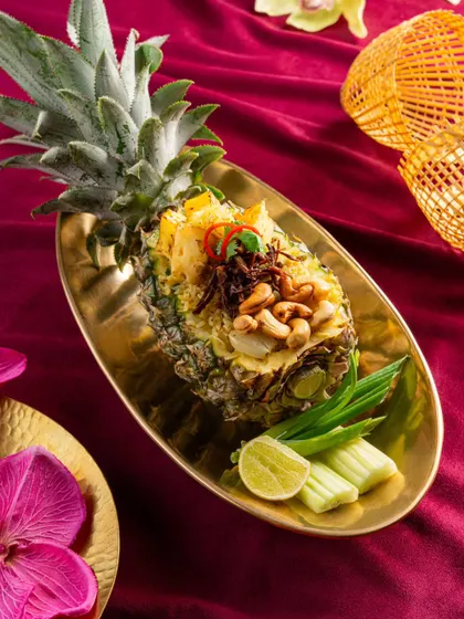 Pineapple fried rice from Nara Thai, creatively served in a hollowed-out pineapple. This presentation is both traditional and visually spectacular.
