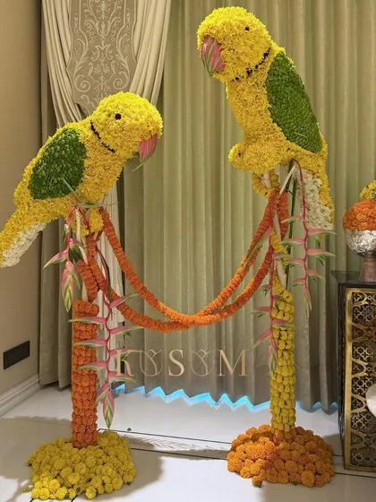 I love blending traditional Indian motifs with my own artistic style. These floral parrot sculptures, crafted from marigolds and chrysanthemums, were designed to bring an auspicious and artistic touch to a client's home entrance.