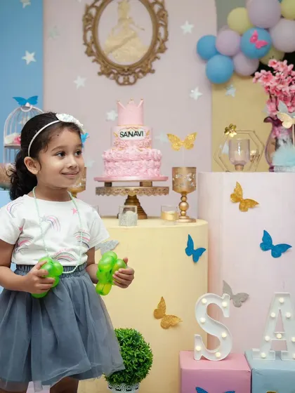 A portrait of the birthday girl amidst the beautiful party decorations. I use the environment to frame the subject and tell the story of the day.