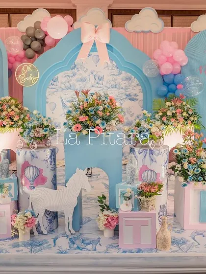 A close-up of the intricate stage decor, showcasing the custom-printed backdrops and themed baby blocks.