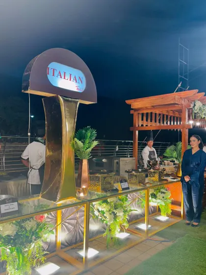 A guest poses by the Italian station, highlighting the inviting and premium setup.