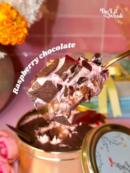 A close-up of our Raspberry Chocolate Dream Cake, showing the perfect bite. The combination of tart raspberry, rich chocolate, and light cream is absolutely irresistible.