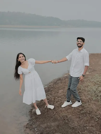 A playful, leaning pose on the edge of the lake, showing their fun-loving connection.