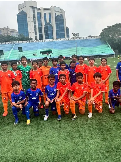Our U11 team with their opponents BFC, showing sportsmanship under gloomy skies.