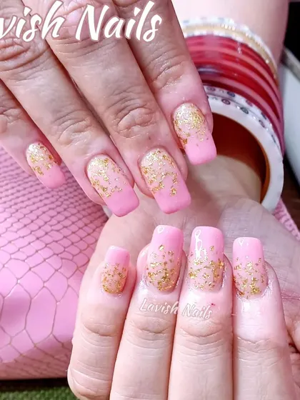 Soft pink square nails are elevated with a scattering of delicate gold foil flakes, creating a look of suspended gold.