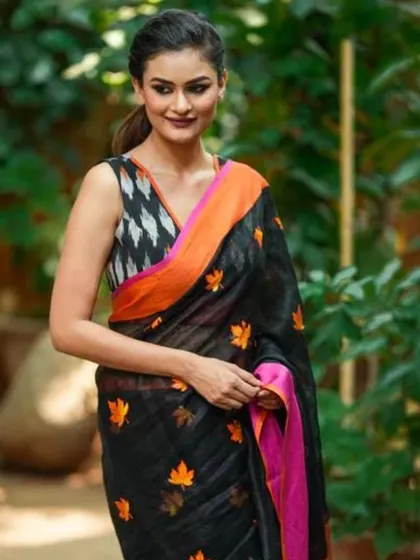 Another look at the black linen saree with orange maple leaf embroidery, paired with a modern Ikkat print blouse for a stylish, fusion look.