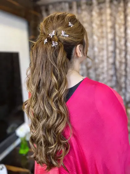 A textured ponytail adorned with delicate butterfly clips, a whimsical and romantic choice.