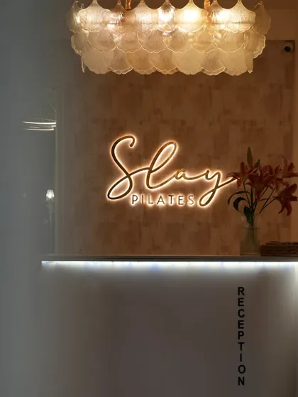 The first thing you see when you walk in. The Slay Pilates sign is a reminder that you're here to conquer your goals.